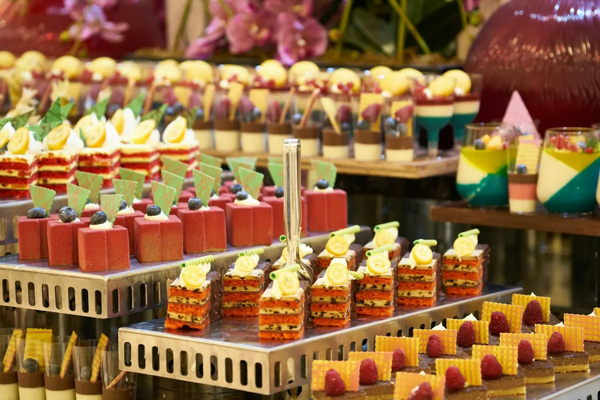 Dessert table with layered cakes and pastries