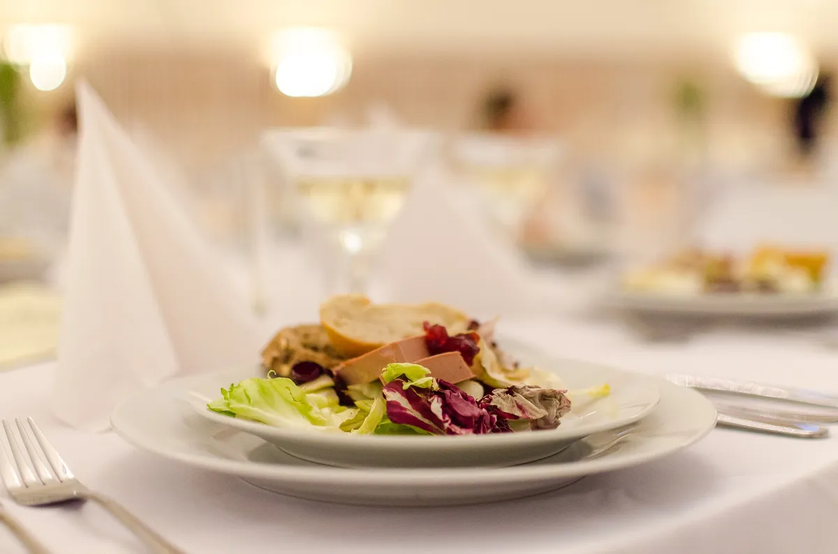 Plated salad course at a set event table